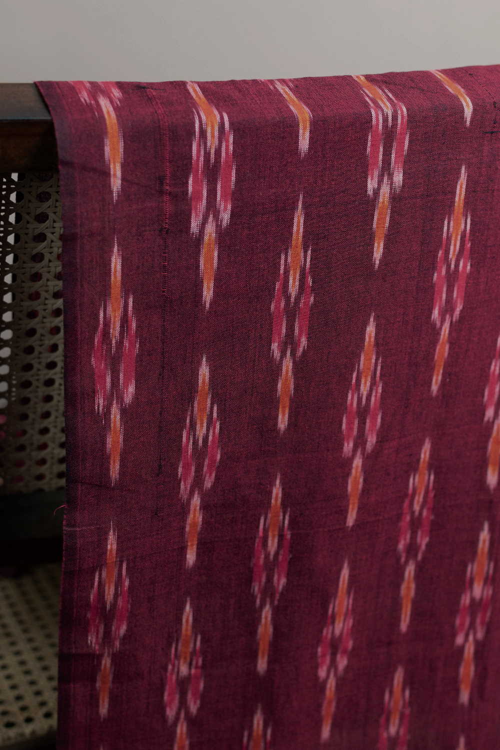 Butta on Pinkish Maroon Ikat Cotton Fabric