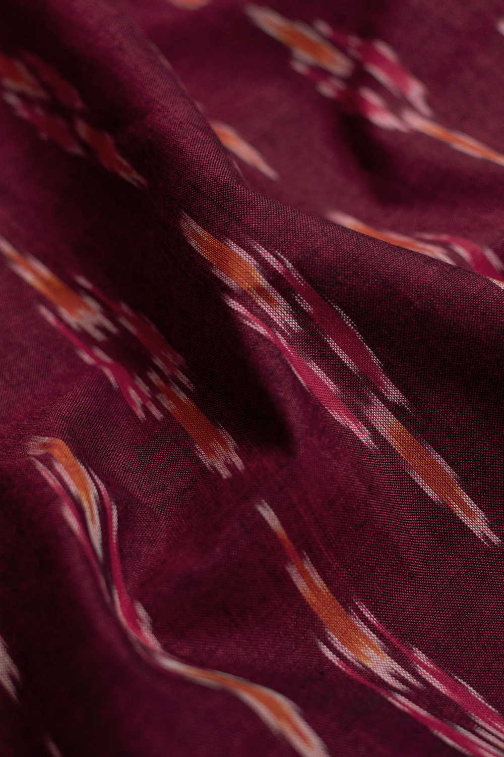 Butta on Pinkish Maroon Ikat Cotton Fabric