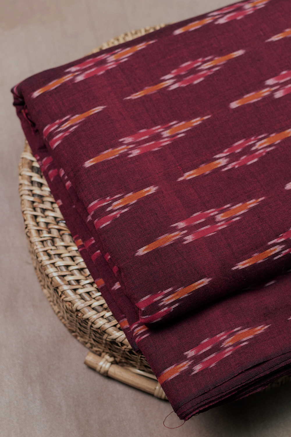 Butta on Pinkish Maroon Ikat Cotton Fabric