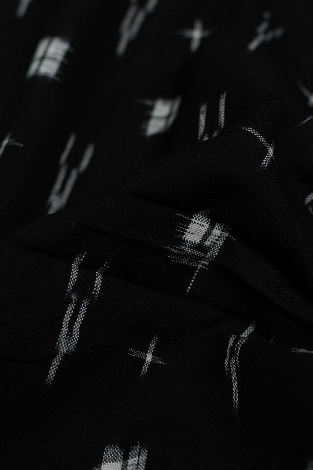 Cream Patterns on Black Ikat Cotton Fabric