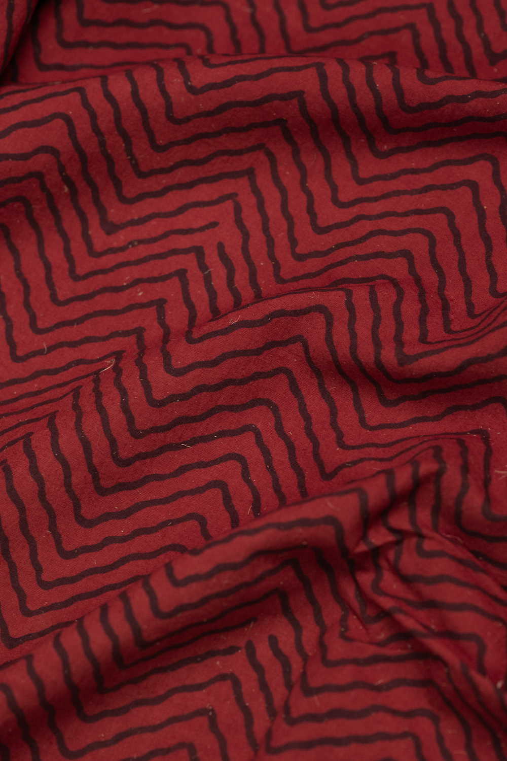 Chevron Pattern on Maroon Ajrak Cotton Fabric