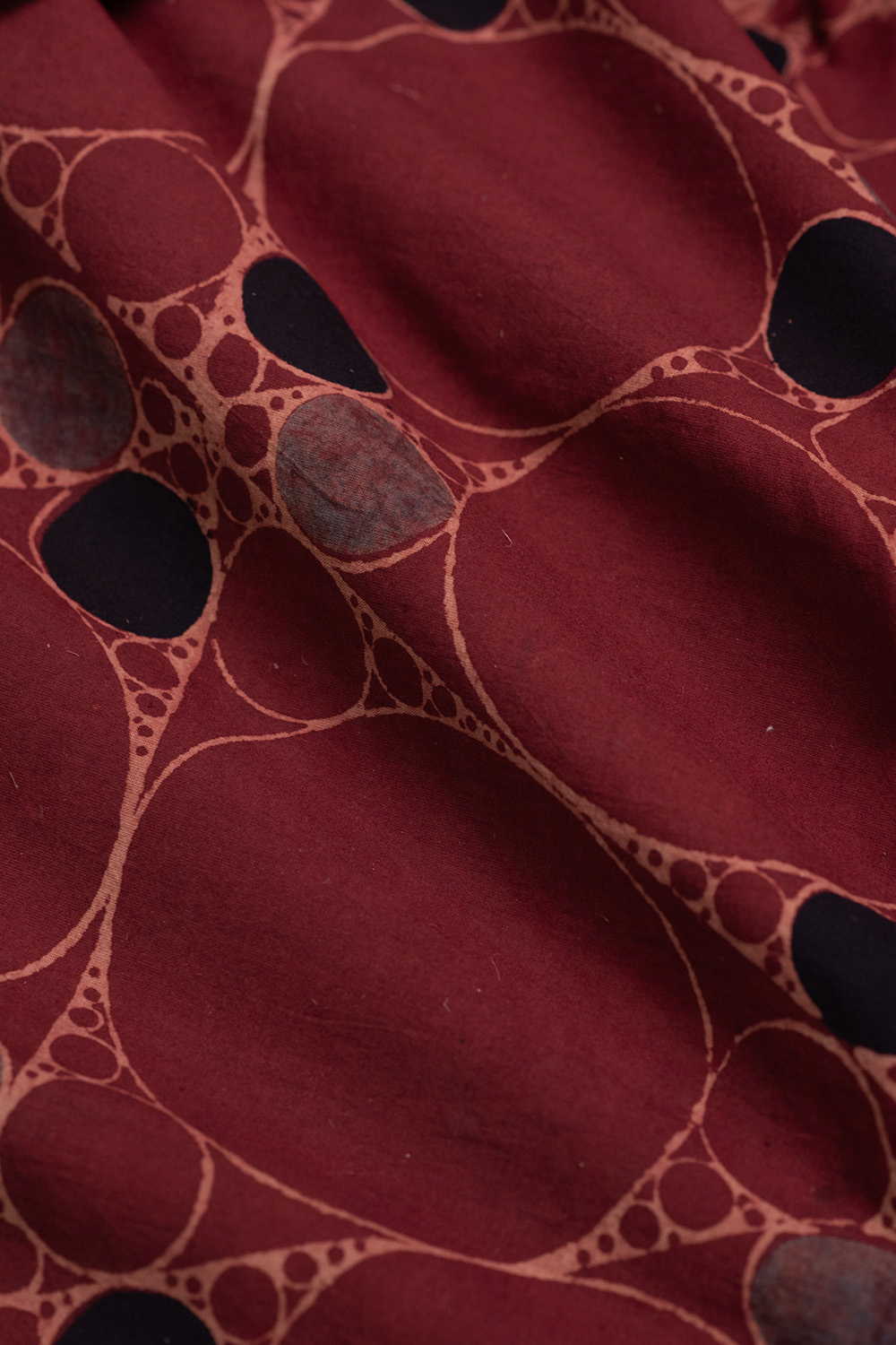 Irregular Circles on Maroon Ajrak Cotton Fabric